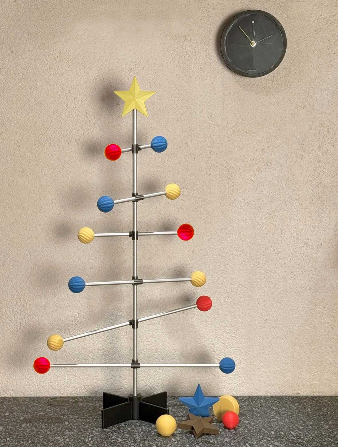Bauhaus Colorful Christmas tree with star on top against a beige wall.