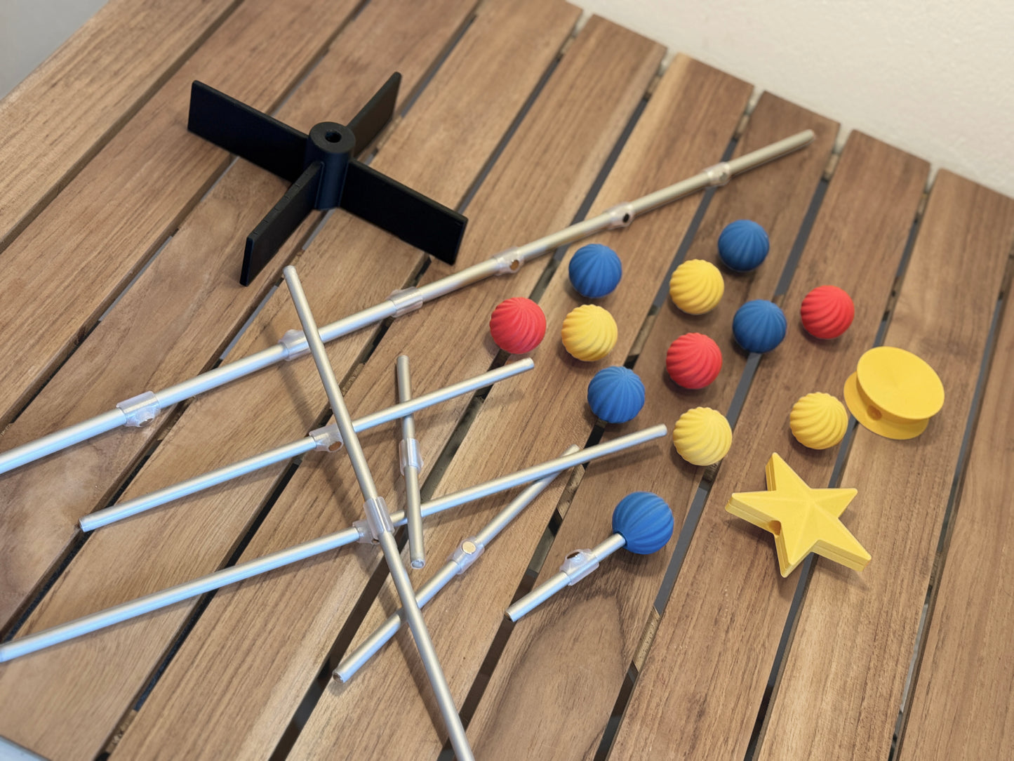 Modern modular for Bauhaus tree items including sticks, colorful ornament, and a star on a wooden surface
