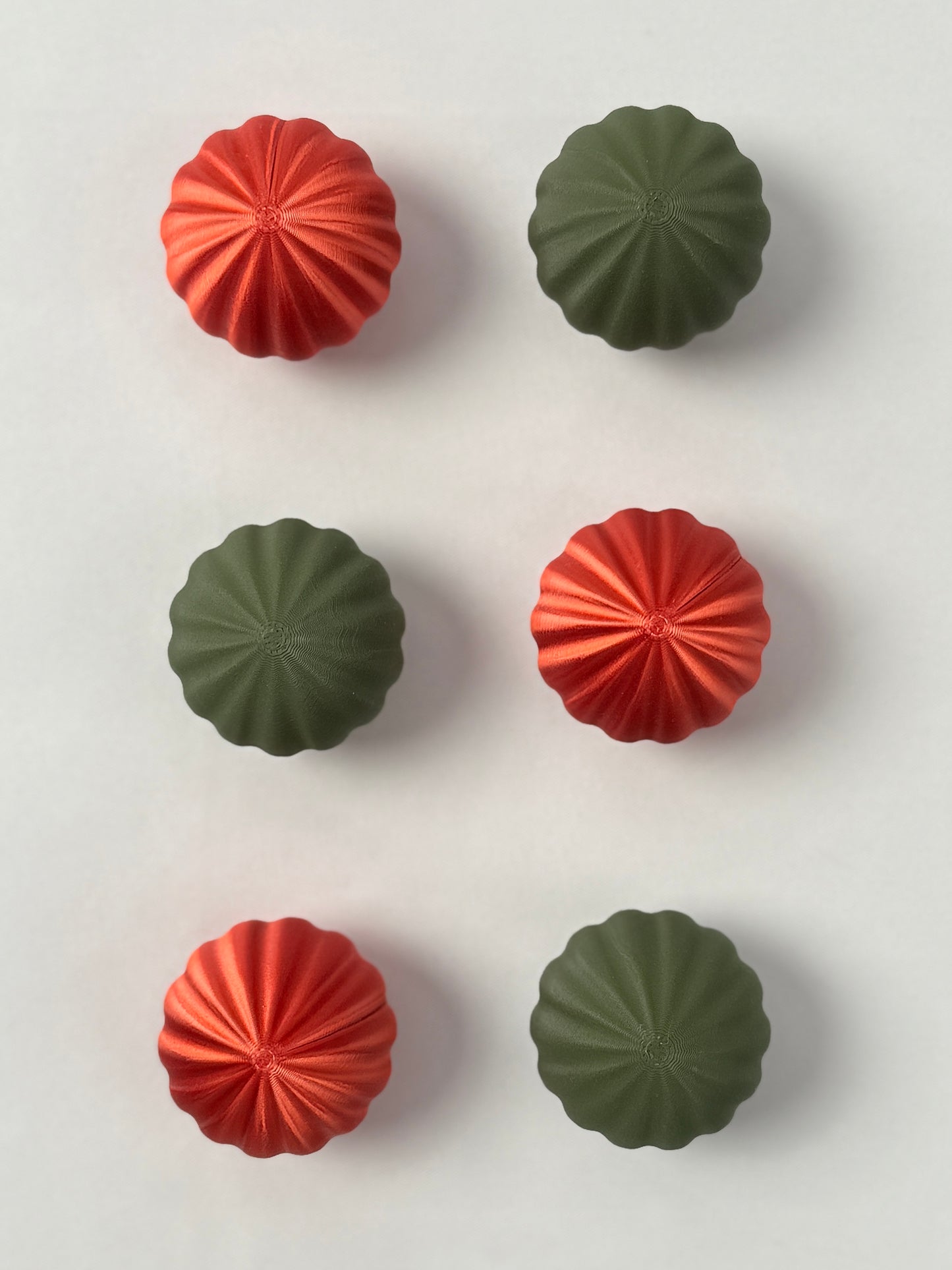Red and green colored spherical shaped Christmas ornament