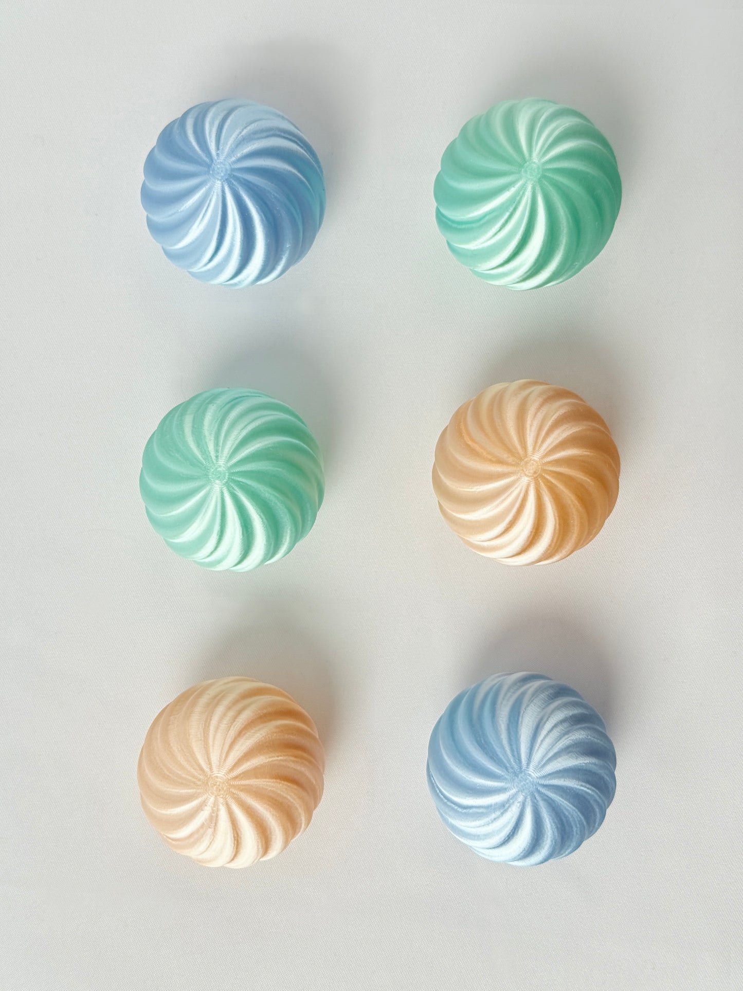 Pastel green, baby blue and mint green colored spherical shaped Christmas ornament