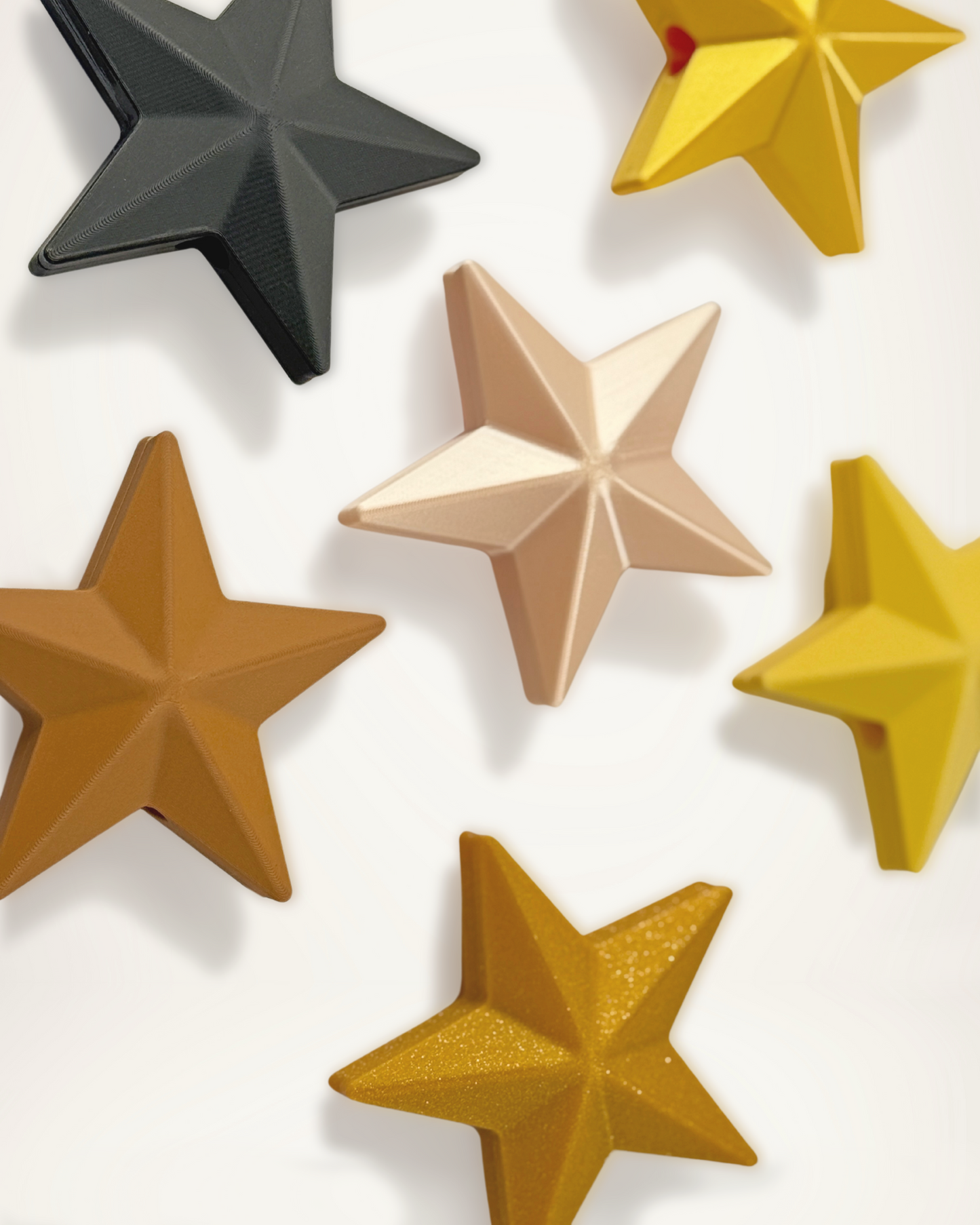 Set of Christmas ornament star objects in various colors on a white background