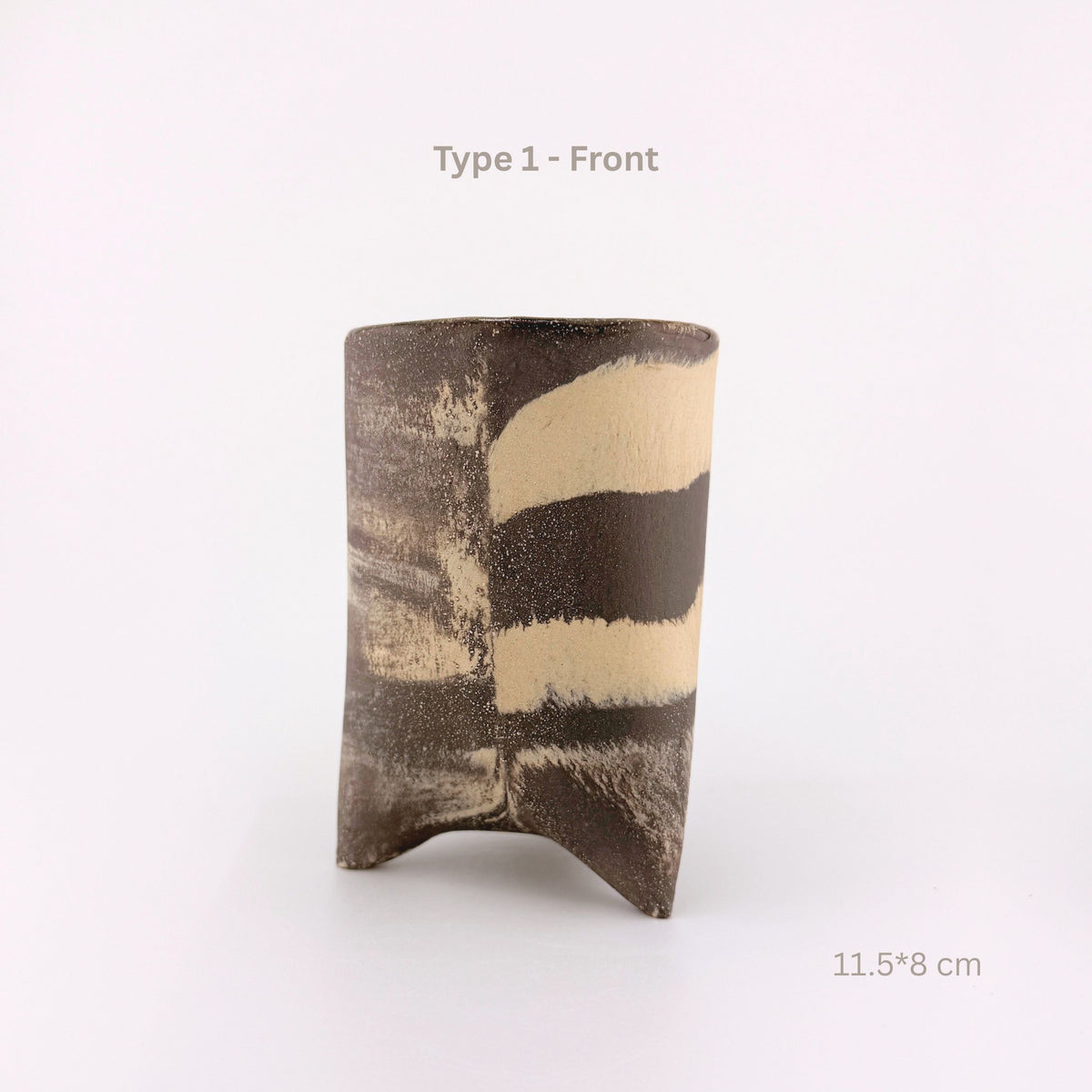 A handmade ceramic cup with a textured, organic shape and abstract black and beige stripes, shown on a white background with text overlays indicating 'Type 1 - Front' and dimensions '11.5*8 cm'.