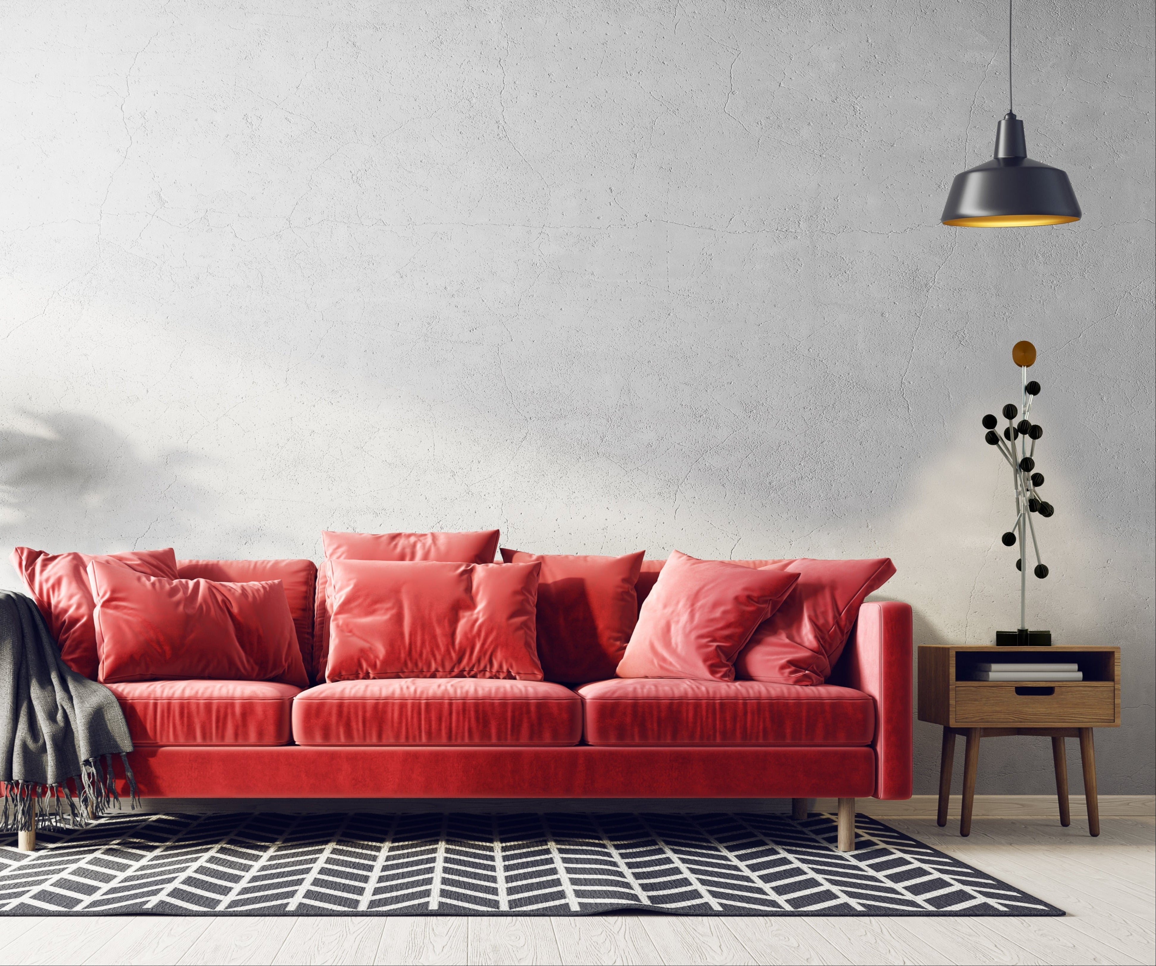 Red sofa with decorative pillows in a modern living room setting with a DESY Tree - Modern modular Christmas tree with black spheres .