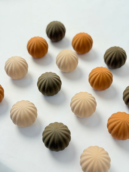 brown, beige, and dark brown colored spherical shaped Christmas ornament on a white background
