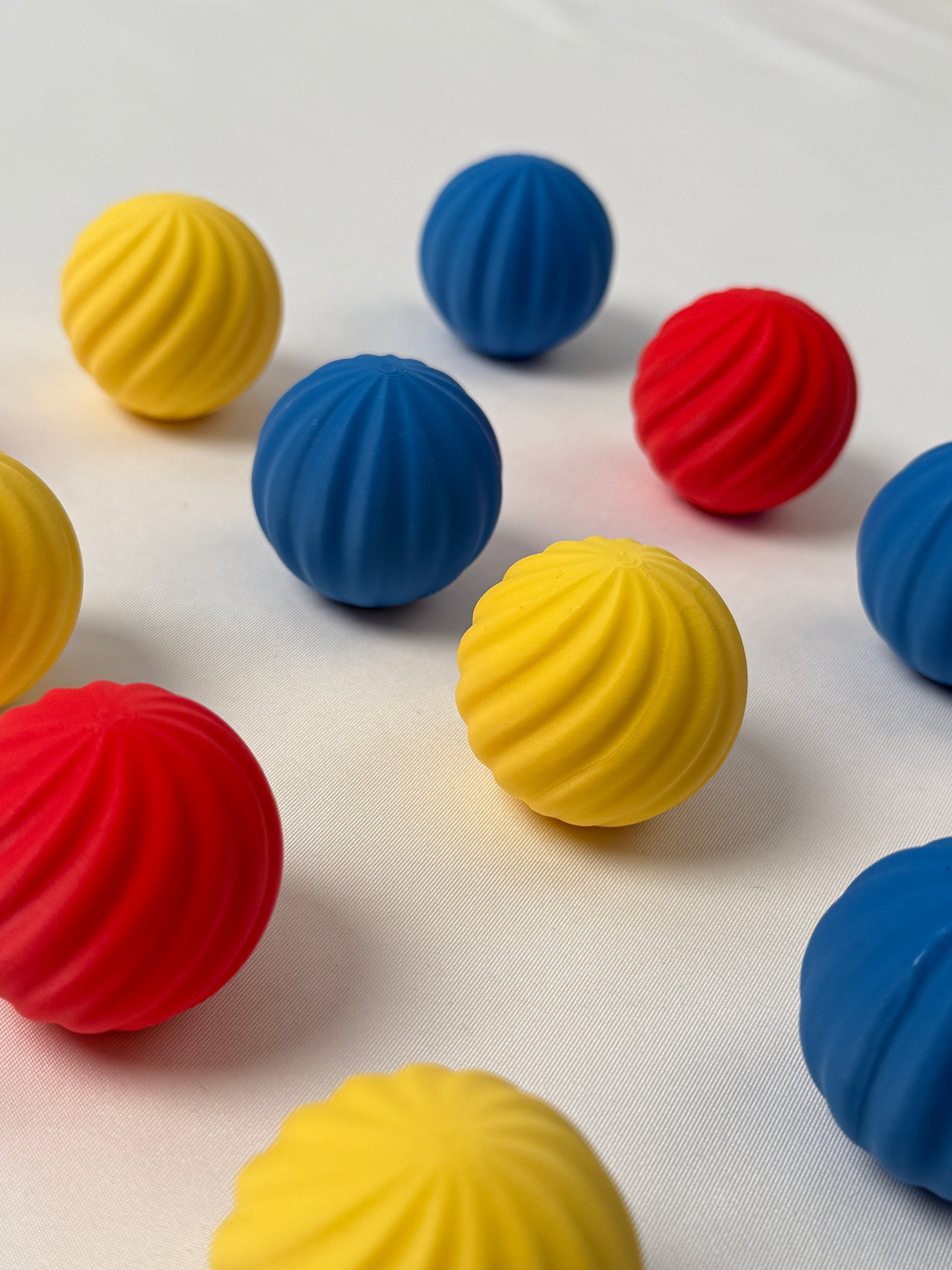 colorful  Bauhaus blue , red and yellow colored spherical shaped Christmas ornament on a white background