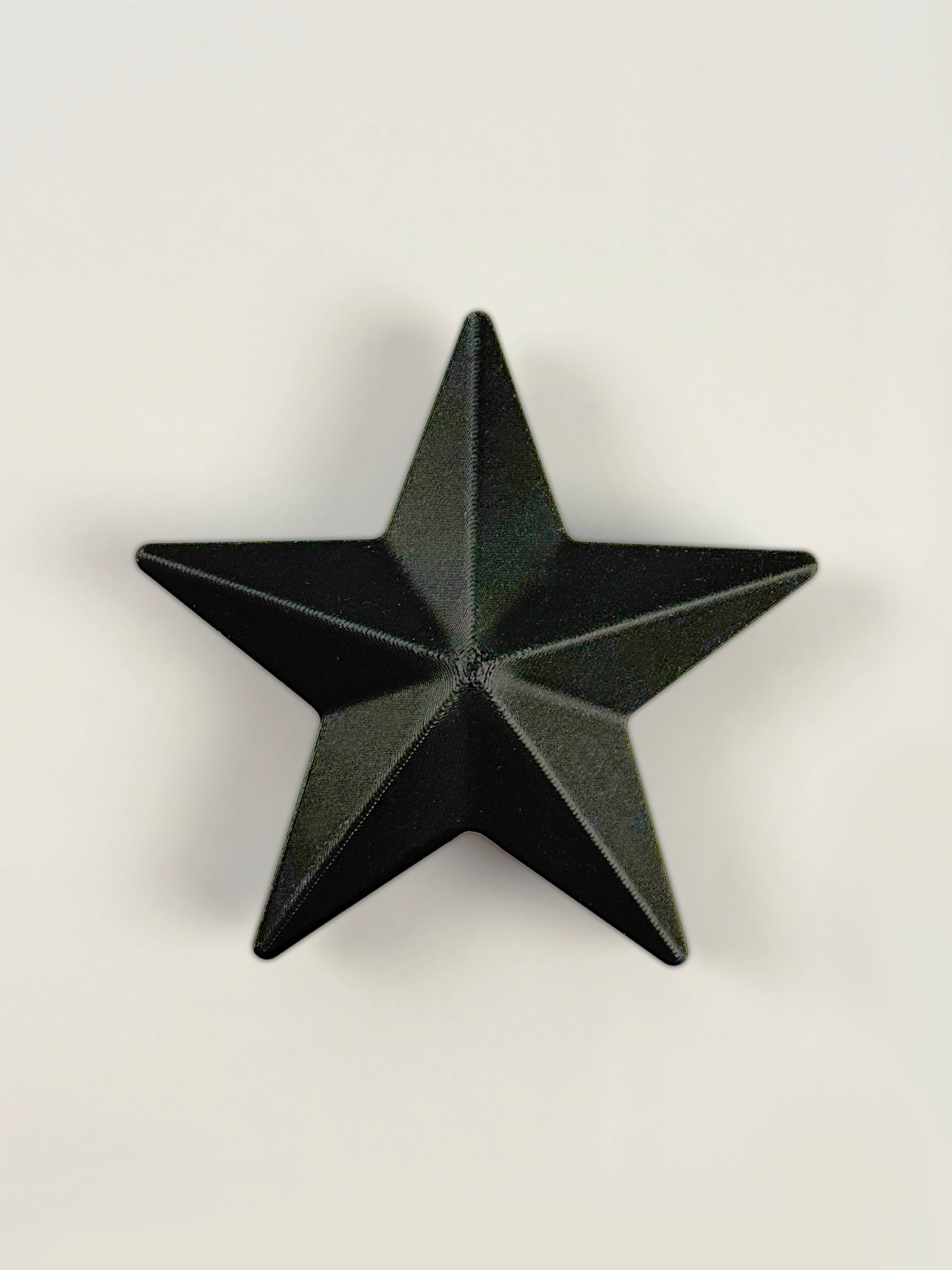 Black 3D print star object / ornament on a white background