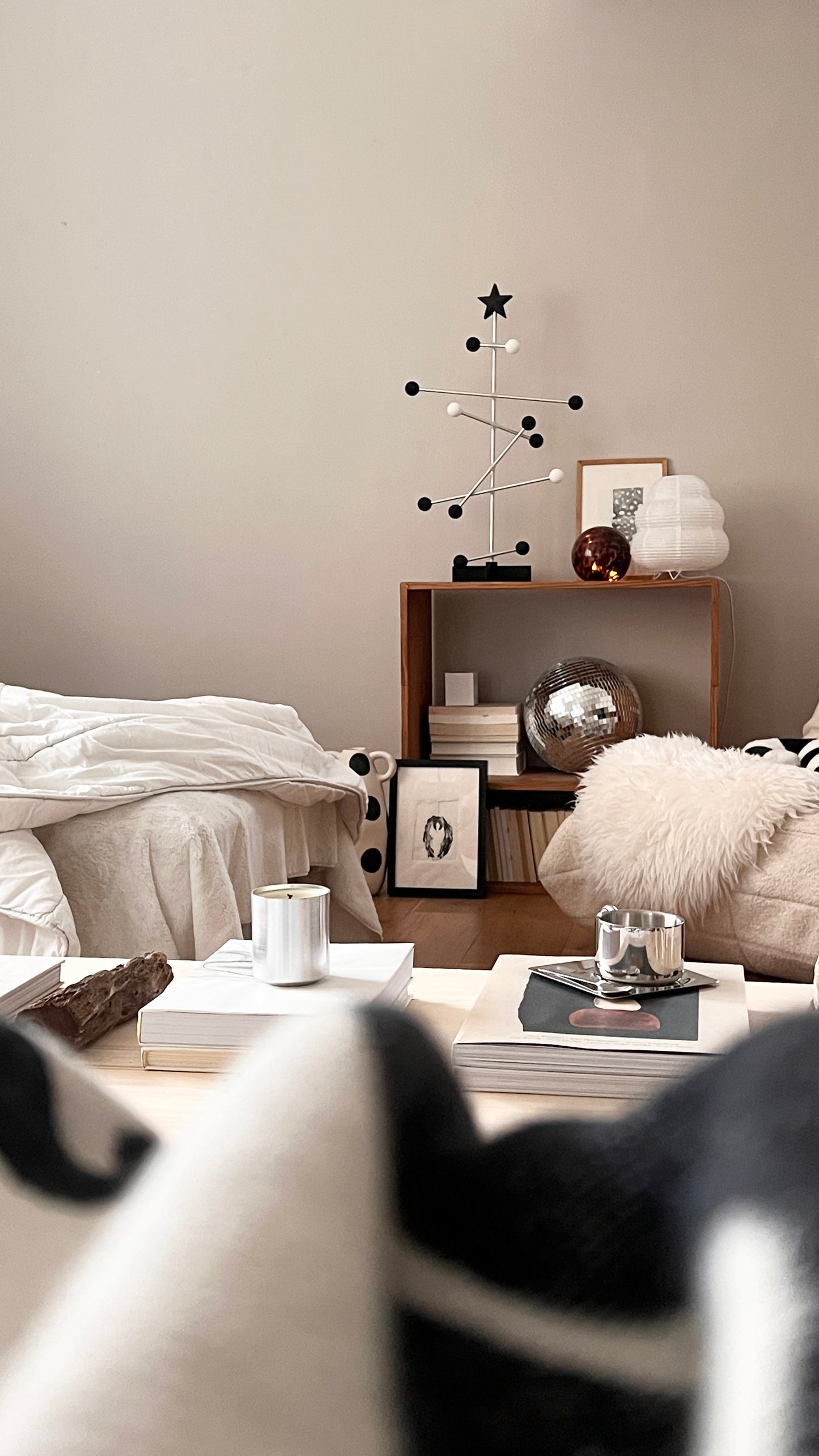 Modern living room with a coffee table, armchair, and decorative items.