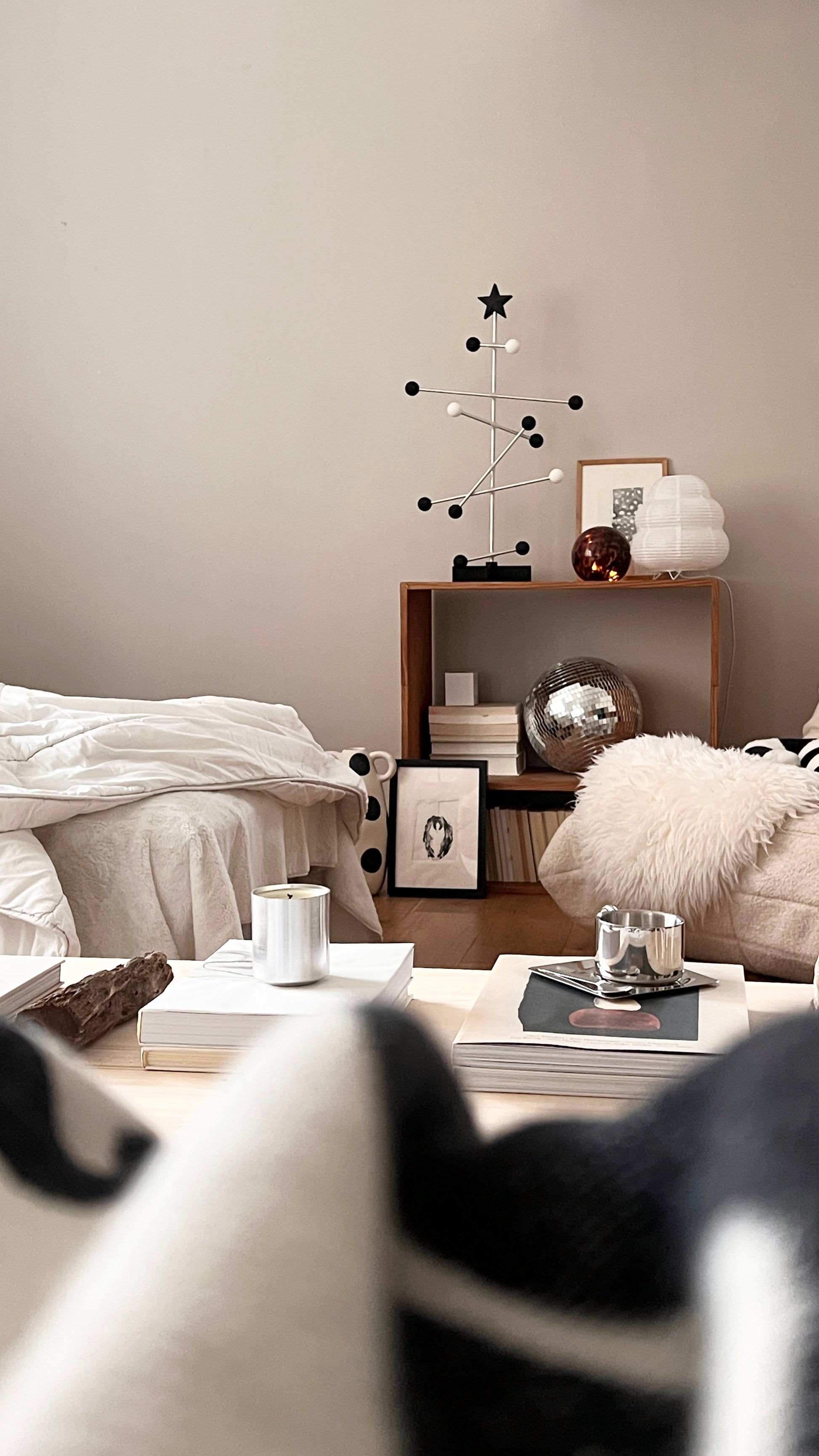 Modern living room with a coffee table, armchair, and decorative items.