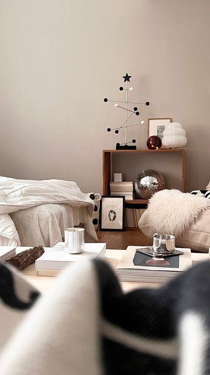 Modern living room with a coffee table, armchair, and decorative items.