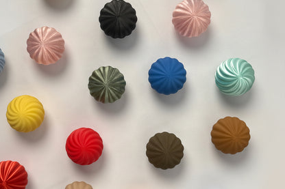 Assorted colorful candy buttons on a white background