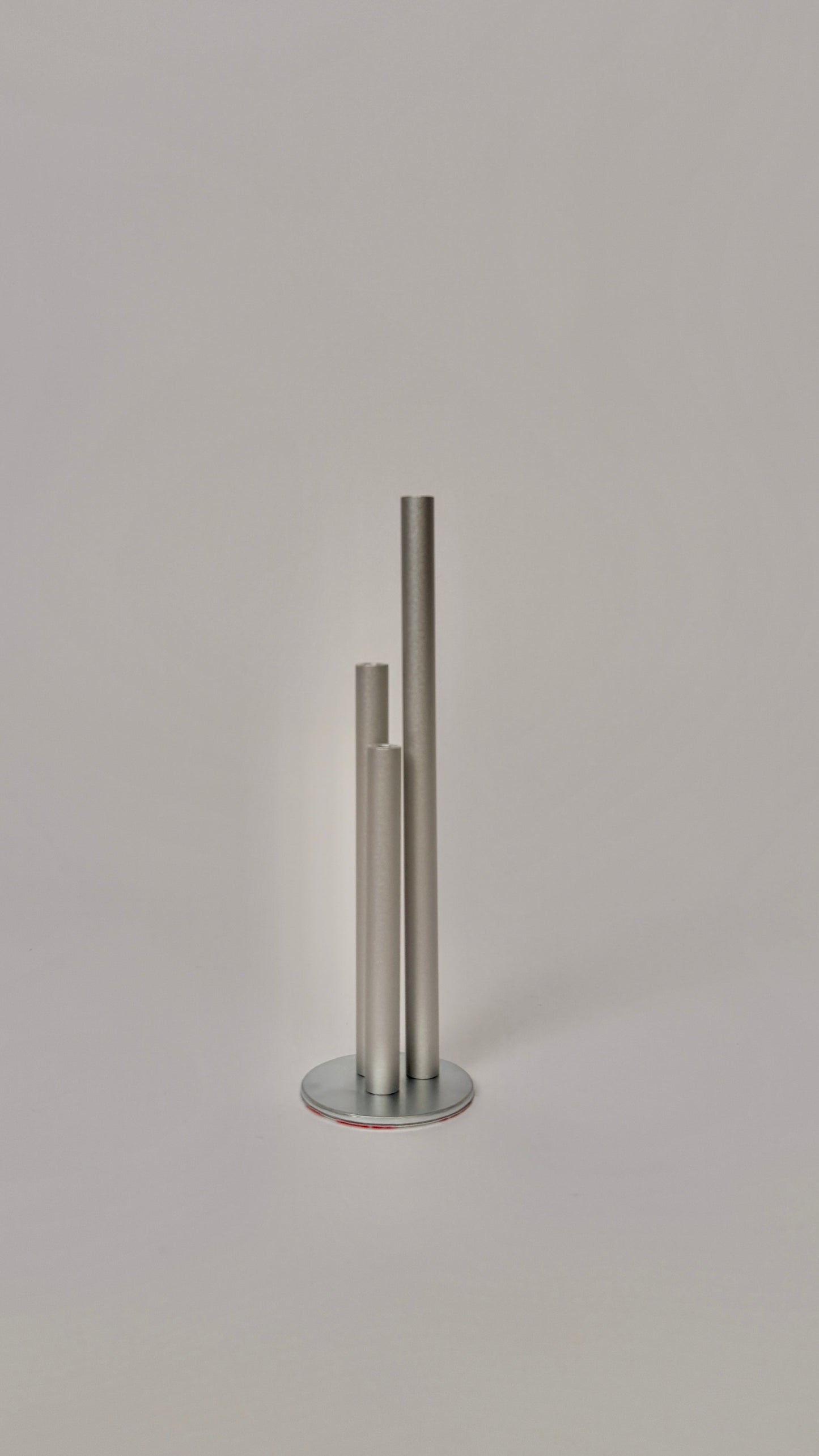 Metallic cylindrical object on a light gray background