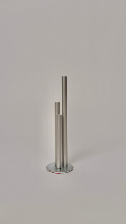 Metallic cylindrical object on a light gray background