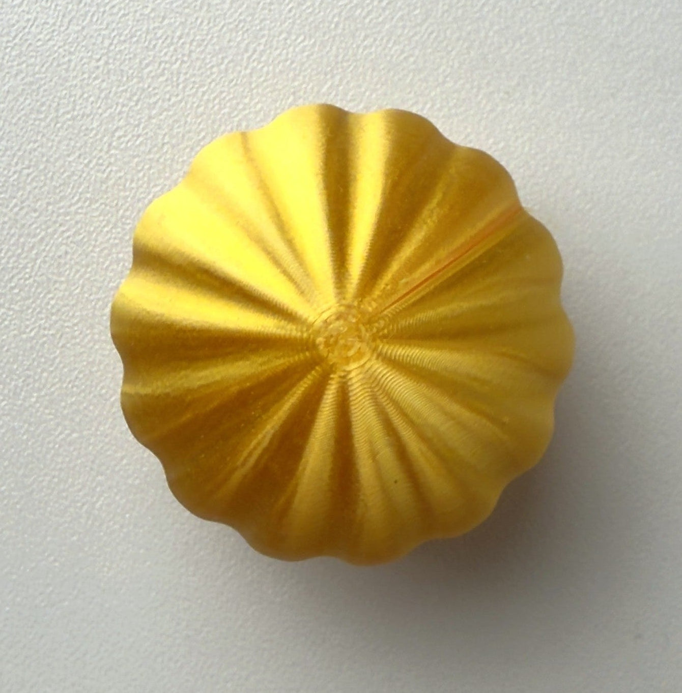 Yellow decorative object on a white background