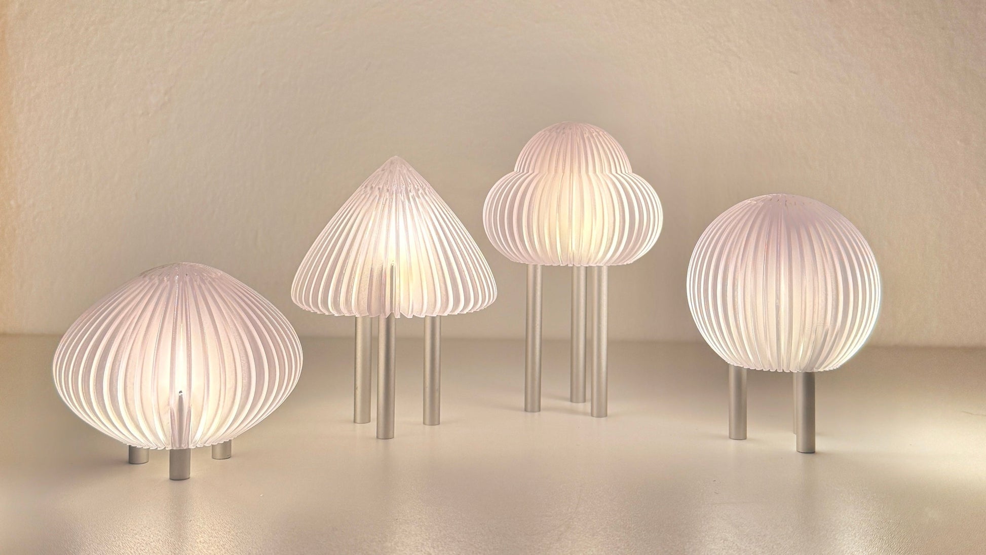 Set of five modern wall lights with ribbed design on a neutral background
