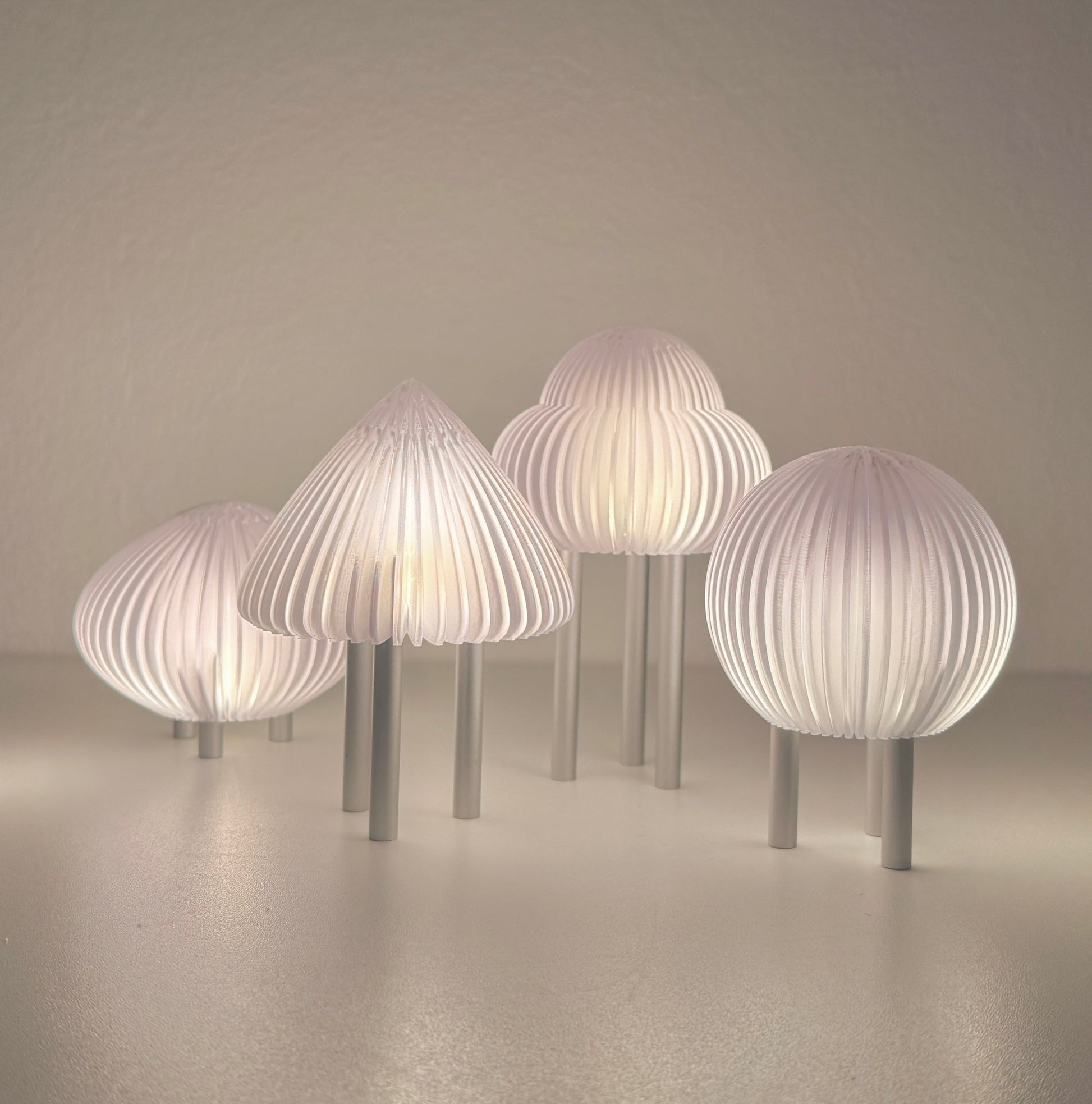 Set of modern mushroom-shaped lamps on a neutral background