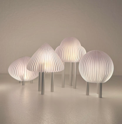Set of modern mushroom-shaped lamps on a neutral background