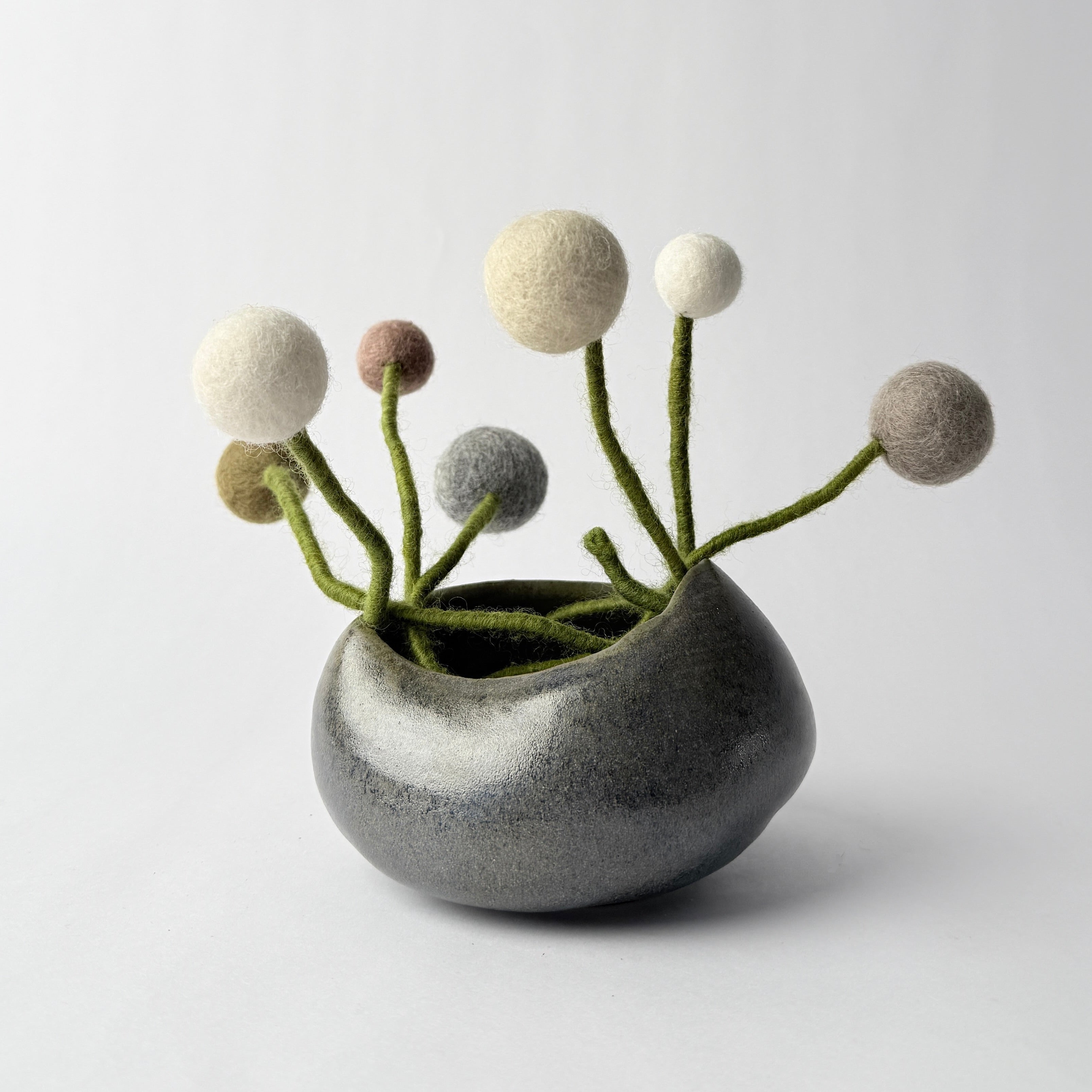 Small ceramic vase with decorative elements on a white background