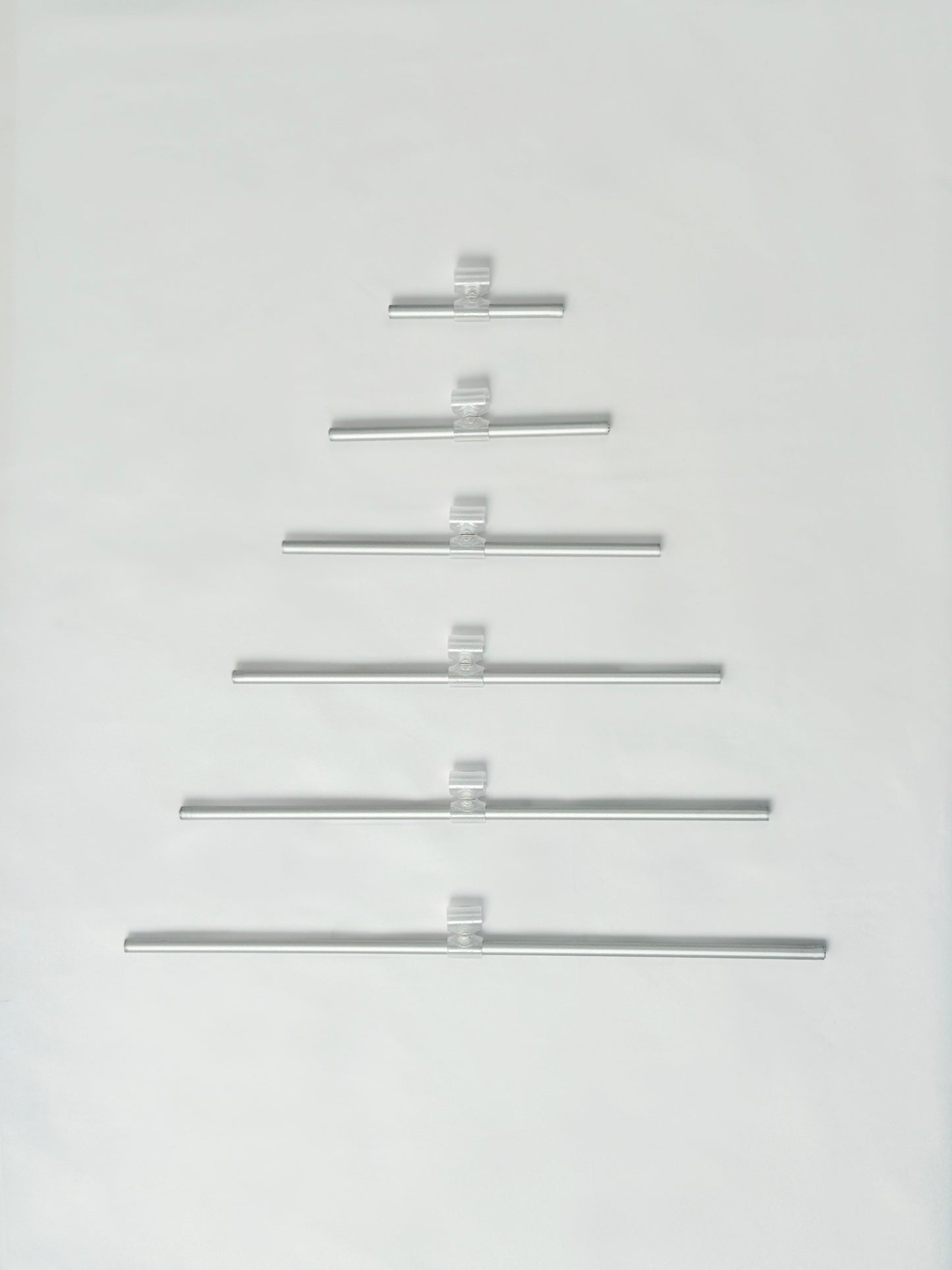 Set of metal rode arranged in a Christmas tree shape on a white background