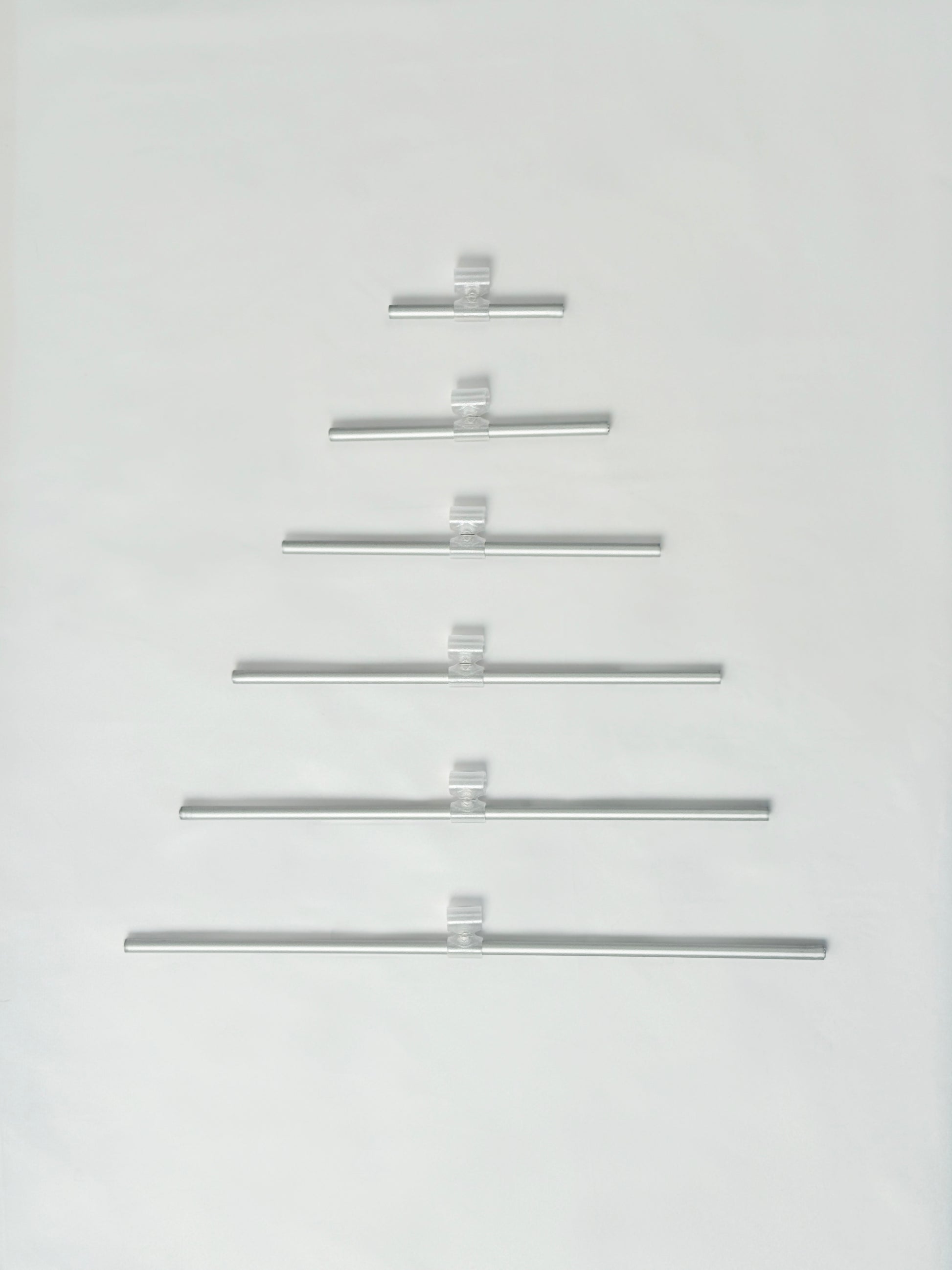 Set of metal rode arranged in a Christmas tree shape on a white background