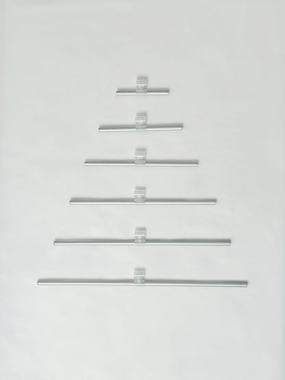 Set of metal rode arranged in a Christmas tree shape on a white background