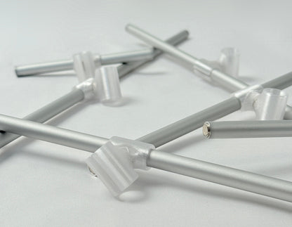 Metallic rode with 3D print connector and magnets on a light gray background