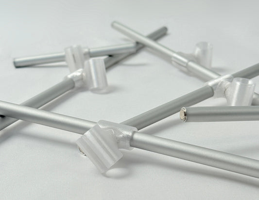 Metallic rode with 3D print connector and magnets on a light gray background