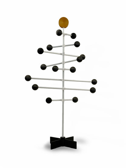 Modern metal rack with black balls and a brown sphere toppers design on a white background