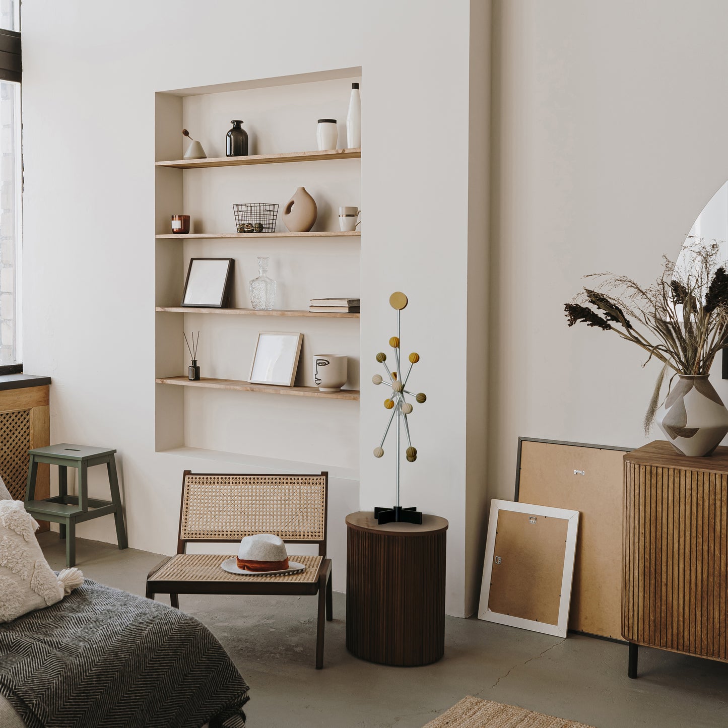 Wooden sideboard with a pastel wooden color decorative tree in a minimalistic room