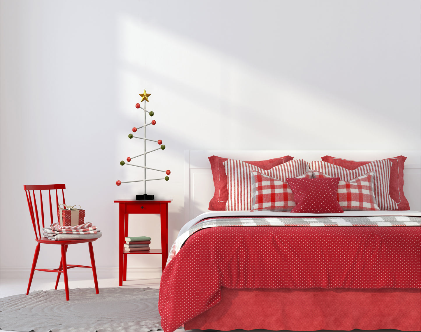 Bedroom with red bedding and decorative modern Christmas tree on the bed side table