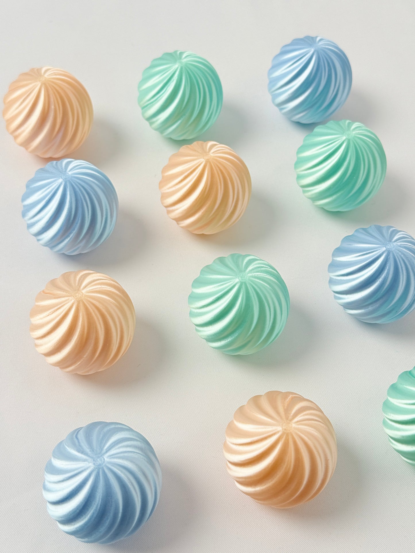 Pastel green, baby blue and mint green colored spherical shaped Christmas ornament 