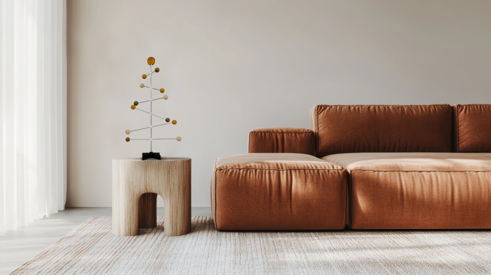 Brown sectional sofa in a modern living room with a small table and decorative wooden Christmas tree.